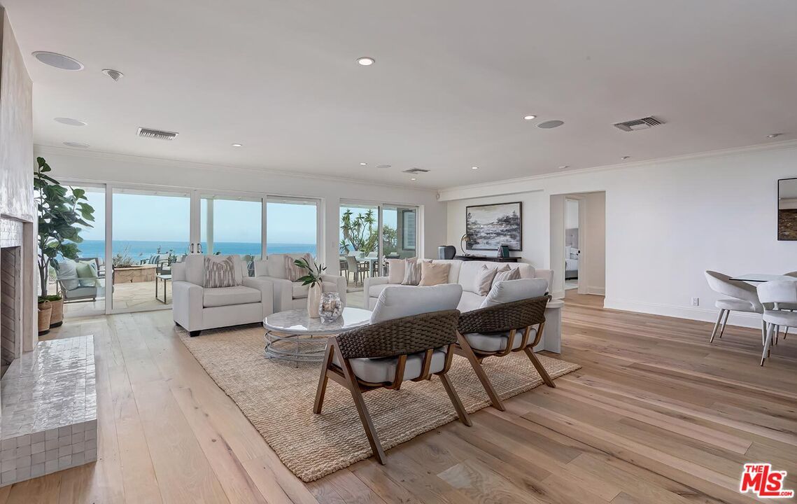 Dining room, Fireplace, Interior, Living room, Recessed Lighting, Water, Wood Texture Flooring