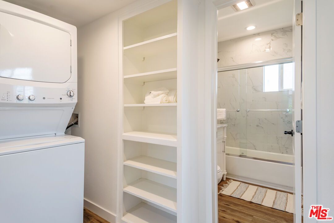 Bathroom, Glass Shower, Interior, Marble Walls, Recessed Lighting, Utility Closets, Washer, Wood Texture Flooring