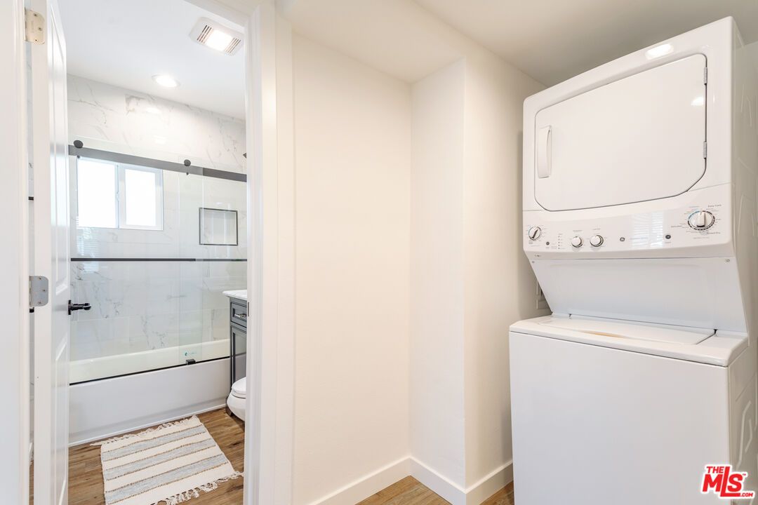 Bathroom, Glass Shower, Interior, Marble Walls, Recessed Lighting, Utility Closets, Washer, Wood Texture Flooring