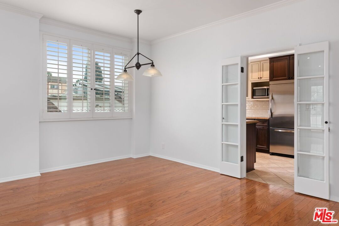 Empty room, Interior, Kitchen, Pendant Lights, Stainless Steel Appliances, Wood Texture Flooring