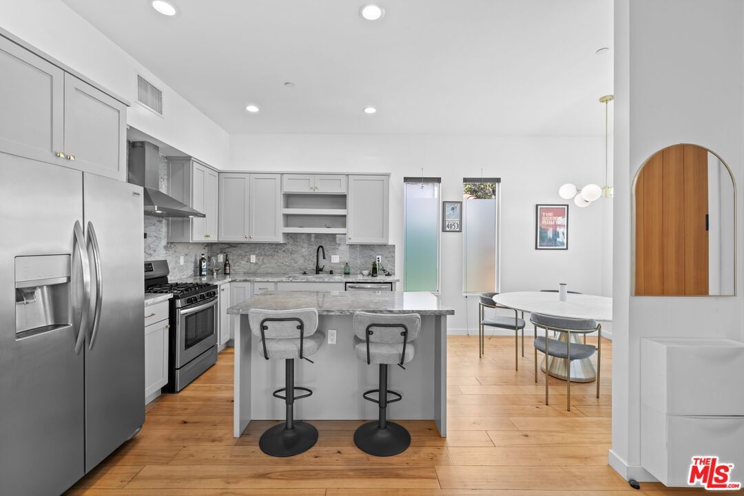 Dining room, Interior, Kitchen, Pendant Lights, Recessed Lighting, Stainless Steel Appliances, Wood Texture Flooring