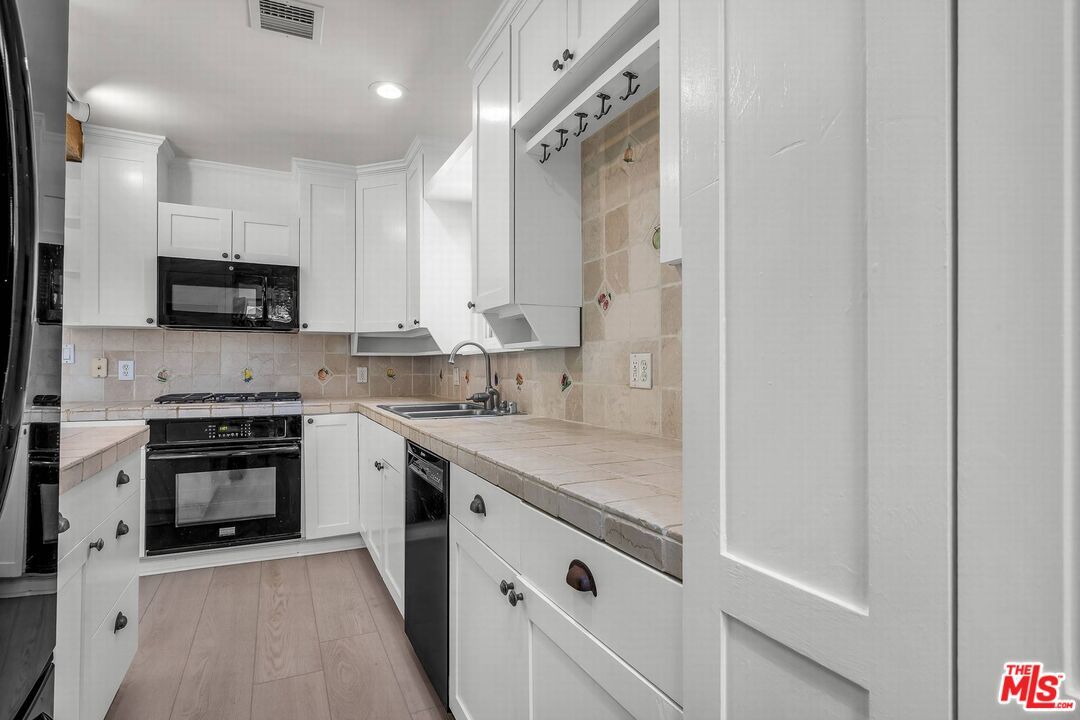 Interior, Kitchen, Recessed Lighting, Tile Countertops, Wood Texture Flooring
