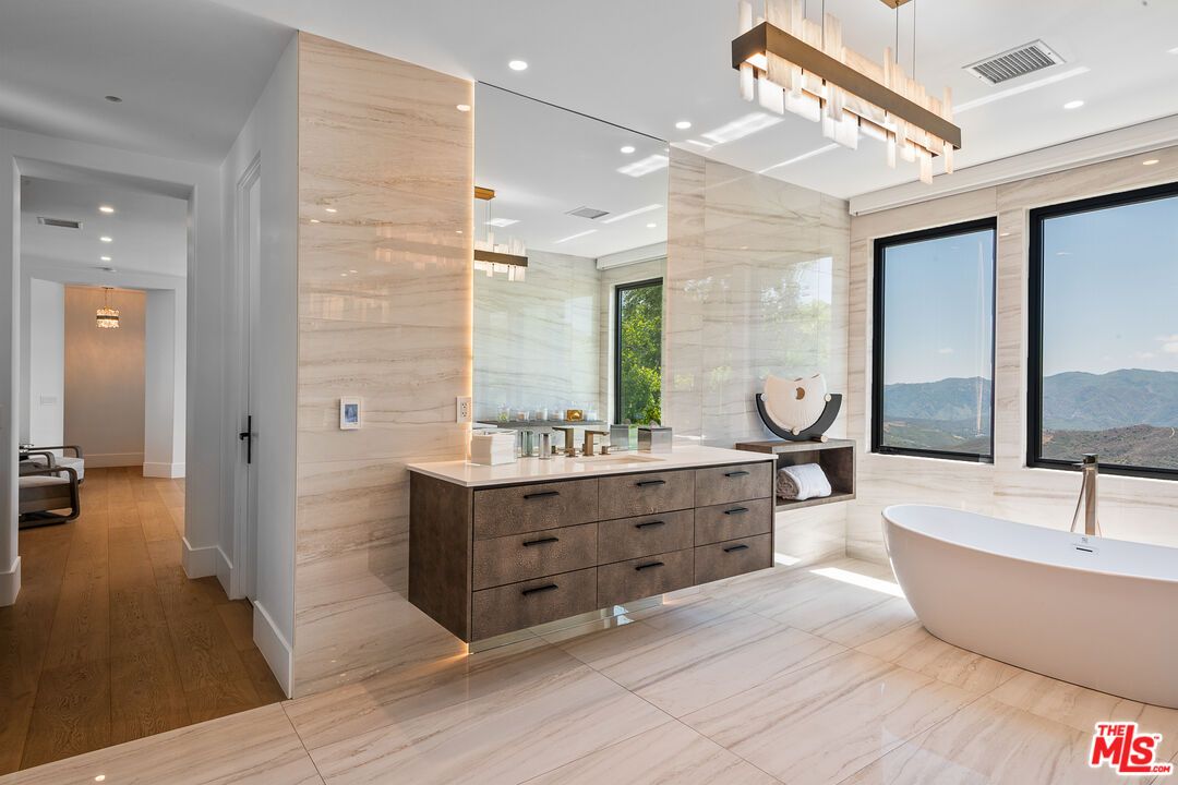 Bathroom, Dual Sink Vanities, Free Standing Baths, Glass Shower, Interior, Marble, Marble Walls, Pendant Lights, Recessed Lighting, Wood Texture Flooring