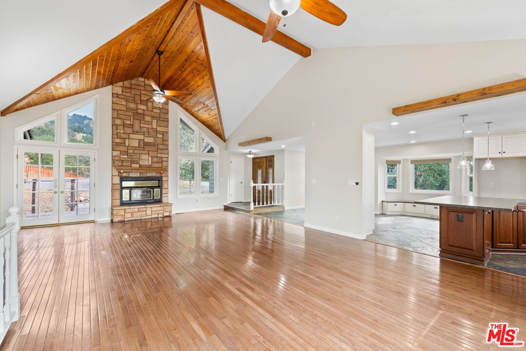Empty room, Fireplace, Interior, Pendant Lights, Recessed Lighting, Stone Walls, Wooden Beams, Wood Texture Flooring