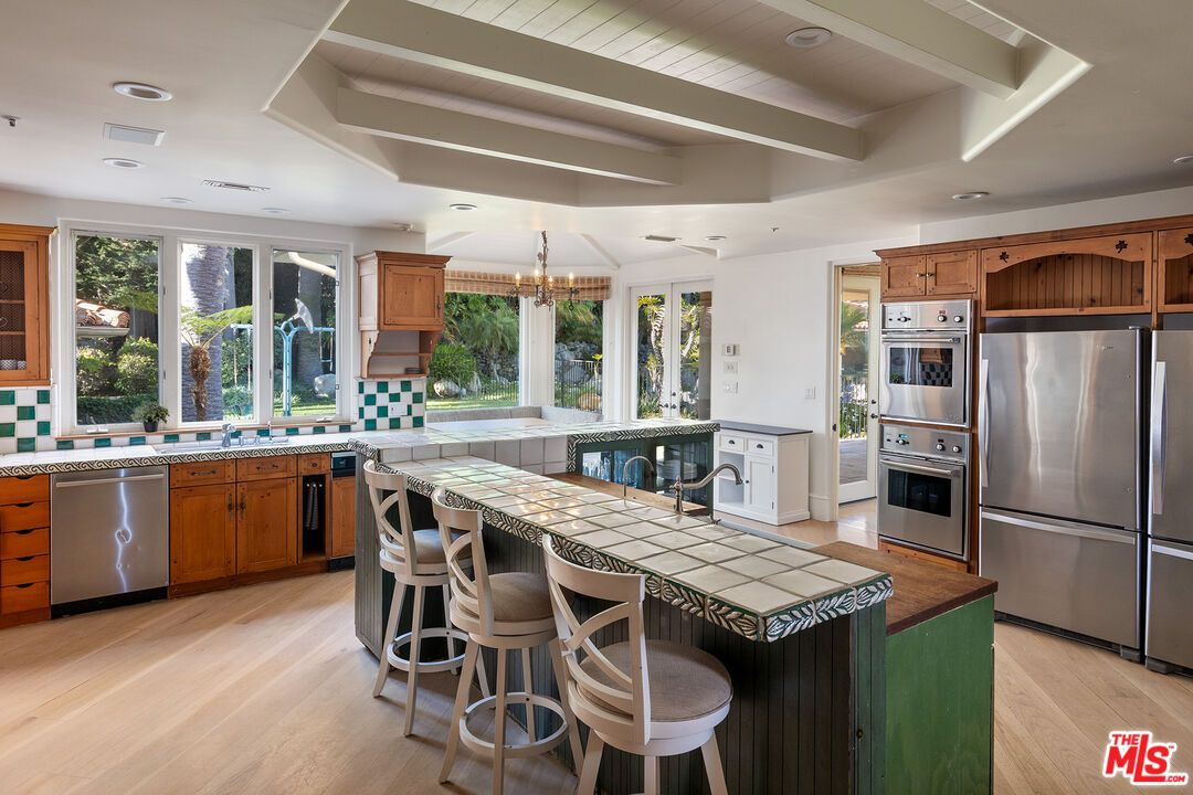 Chandelier, Interior, Kitchen, Recessed Lighting, Stainless Steel Appliances, Tile Countertops, Wood Texture Flooring