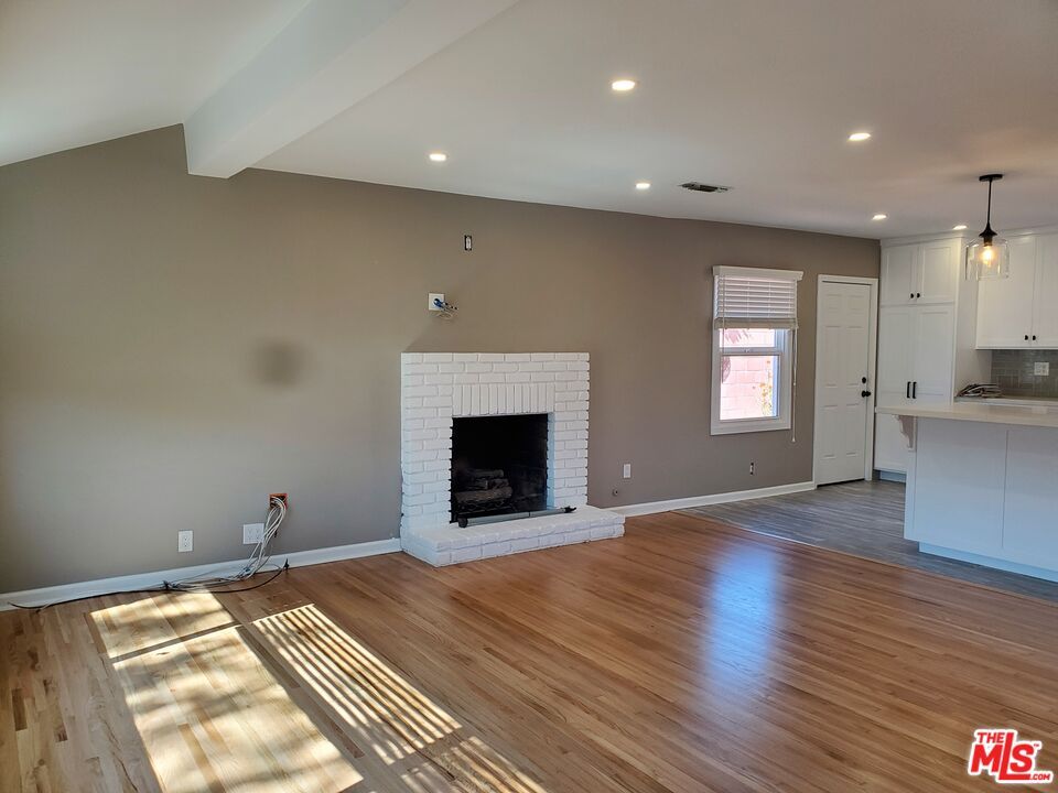 Empty room, Fireplace, Interior, Kitchen, Pendant Lights, Recessed Lighting, Wood Texture Flooring