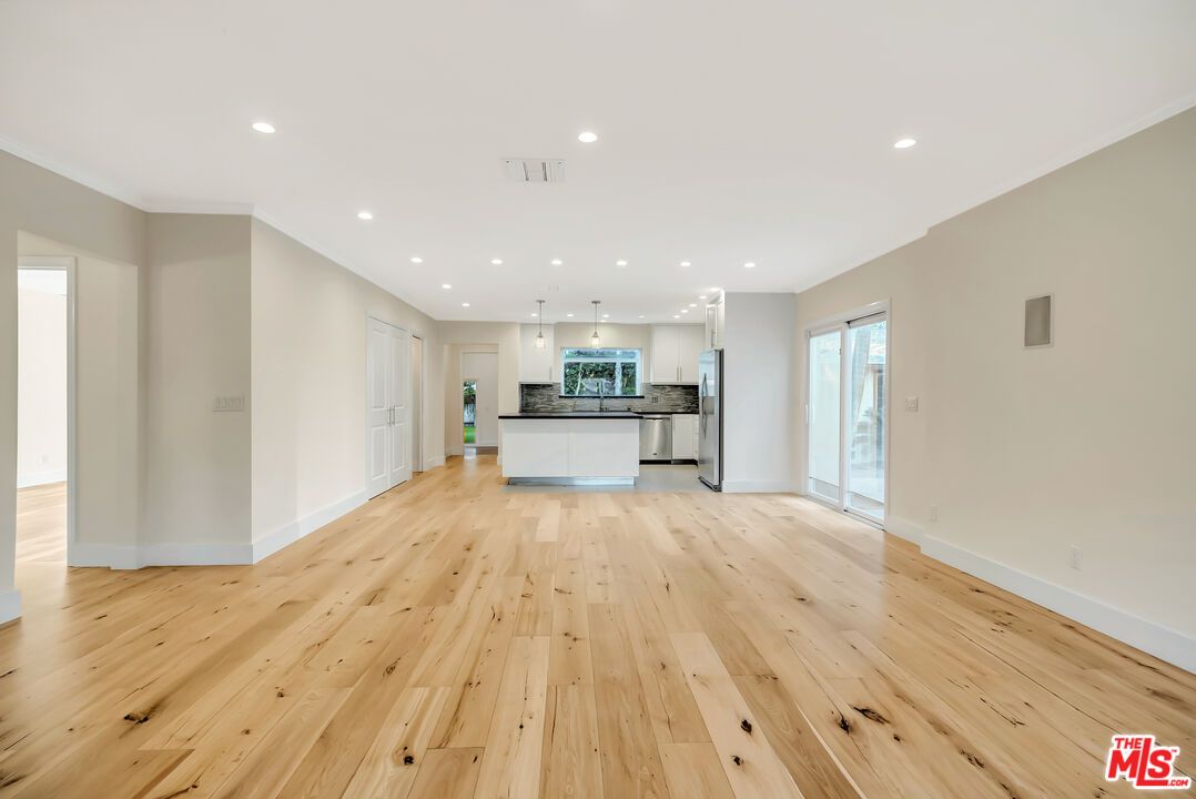 Empty room, Interior, Kitchen, Pendant Lights, Recessed Lighting, Stainless Steel Appliances, Wood Texture Flooring