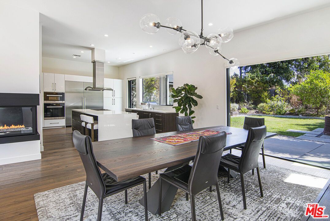 Dining room, Fireplace, Interior, Kitchen, Pendant Lights, Recessed Lighting, Stainless Steel Appliances, Wood Texture Flooring