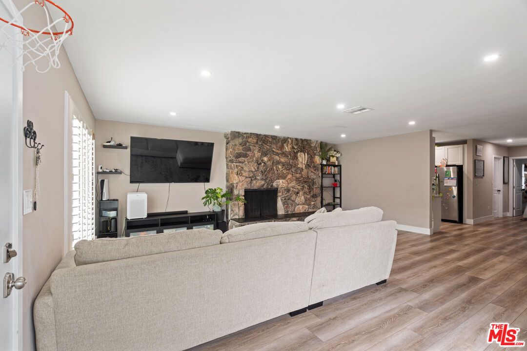 Fireplace, Interior, Living room, Recessed Lighting, Stone Walls, Wood Texture Flooring