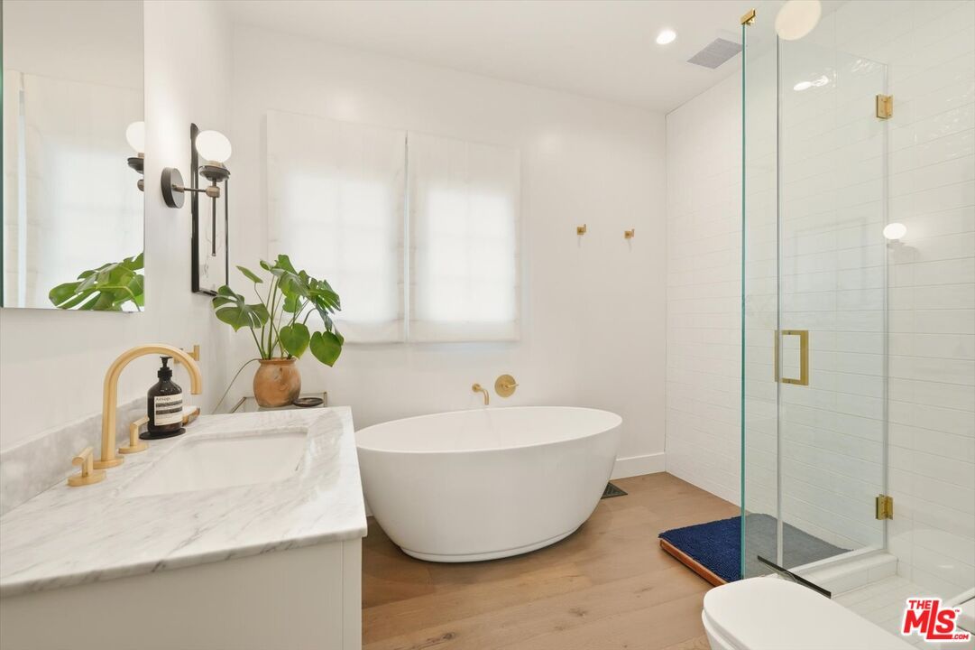 Bathroom, Free Standing Baths, Glass Shower, Interior, Recessed Lighting, Wood Texture Flooring