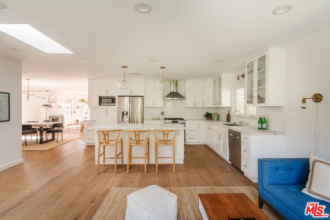 Dining room, Fireplace, Interior, Kitchen, Pendant Lights, Recessed Lighting, Stainless Steel Appliances, Wood Texture Flooring
