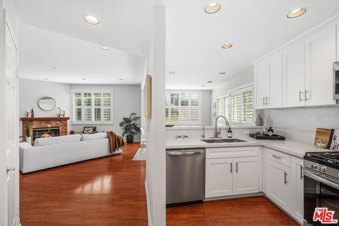 Fireplace, Interior, Kitchen, Living room, Recessed Lighting, Stainless Steel Appliances, Wood Texture Flooring