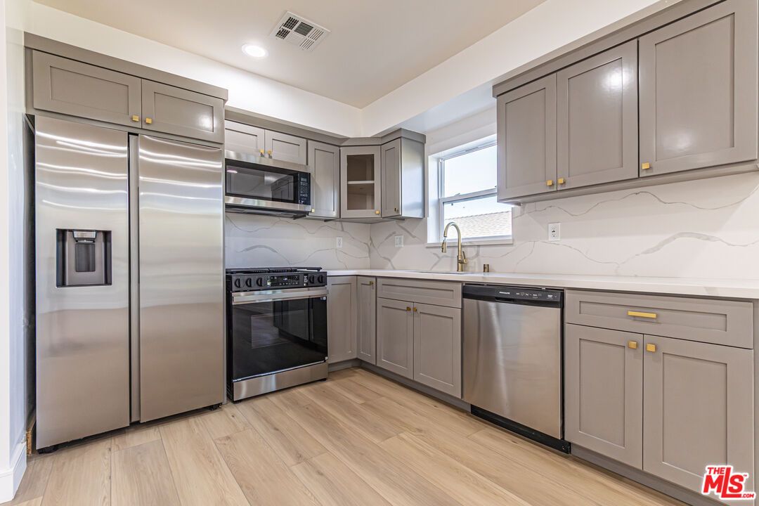 Interior, Kitchen, Marble Walls, Recessed Lighting, Stainless Steel Appliances, Wood Texture Flooring