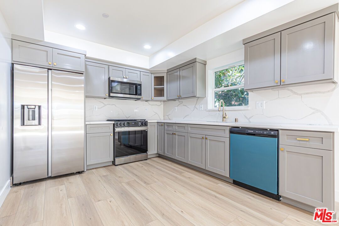 Interior, Kitchen, Marble Walls, Recessed Lighting, Stainless Steel Appliances, Wood Texture Flooring