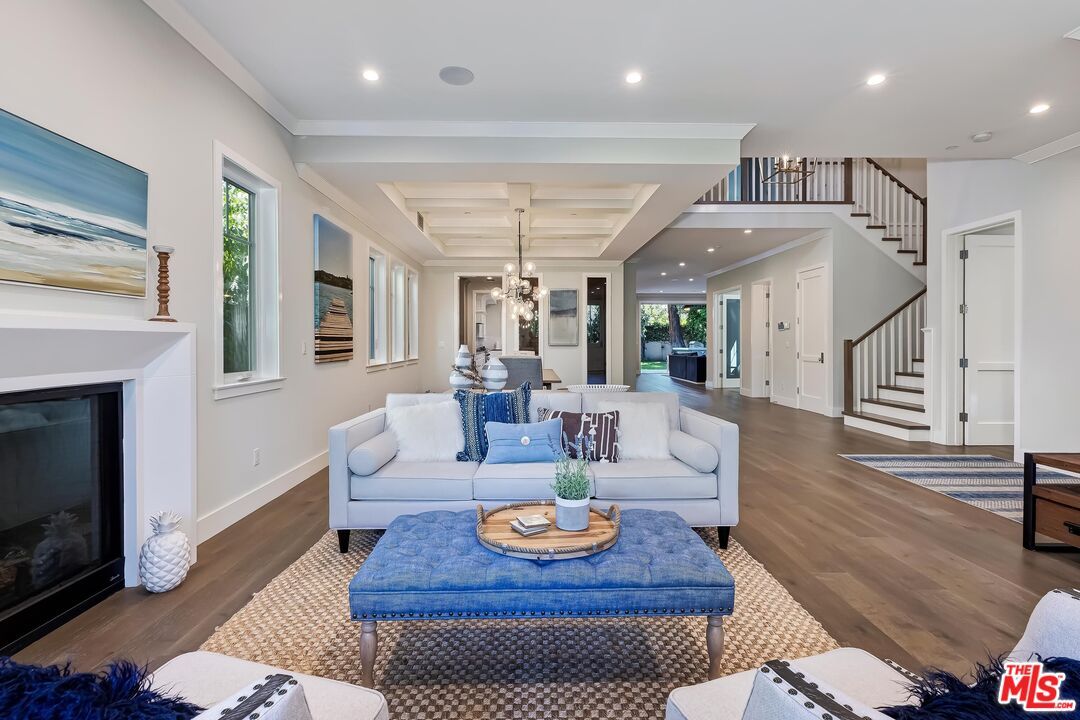 Chandelier, Dining room, Fireplace, Interior, Living room, Pendant Lights, Recessed Lighting, Wood Texture Flooring