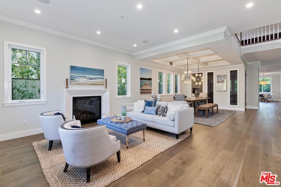 Chandelier, Dining room, Fireplace, Interior, Living room, Pendant Lights, Recessed Lighting, Wood Texture Flooring