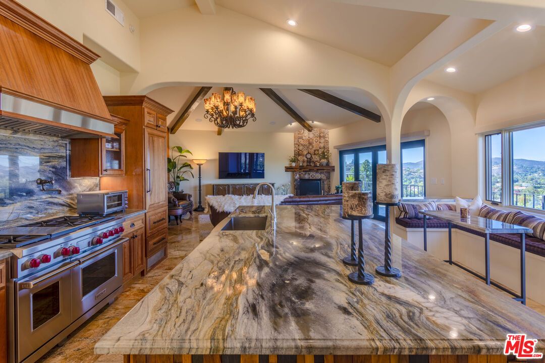 Chandelier, Fireplace, Interior, Kitchen, Living room, Recessed Lighting, Stainless Steel Appliances, Wooden Beams, Wood Texture Flooring