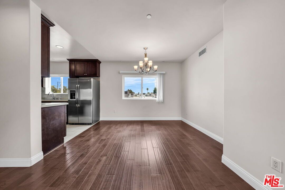 Chandelier, Empty room, Interior, Kitchen, Recessed Lighting, Stainless Steel Appliances, Wood Texture Flooring