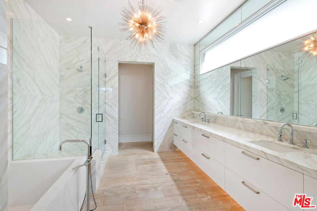 Bathroom, Dual Sink Vanities, Glass Shower, Interior, Marble Walls, Recessed Lighting, Wood Texture Flooring