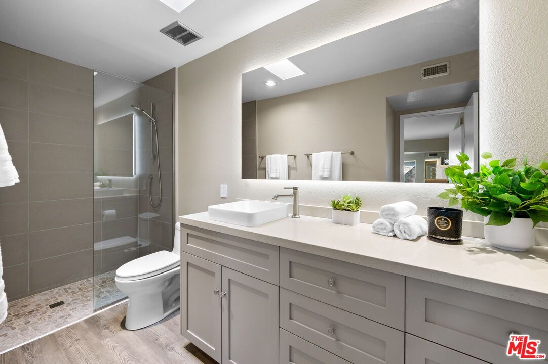 Bathroom, Dual Sink Vanities, Glass Shower, Interior, Recessed Lighting, Wood Texture Flooring