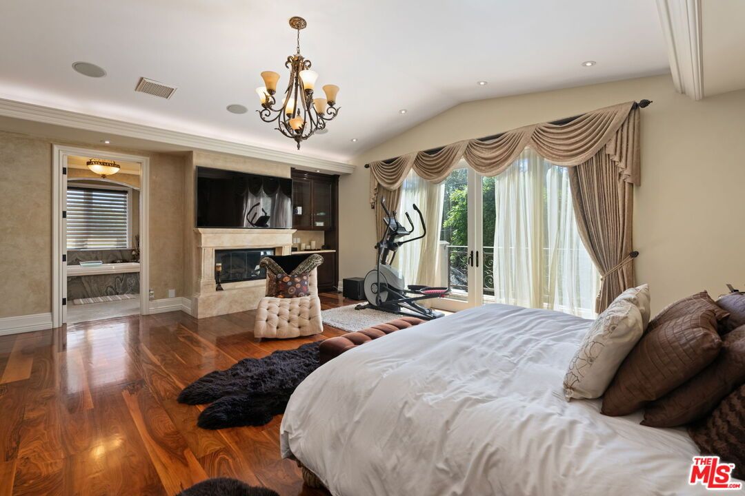 Bedroom, Chandelier, Fireplace, Fitness Equipment, Interior, Recessed Lighting, Wood Texture Flooring