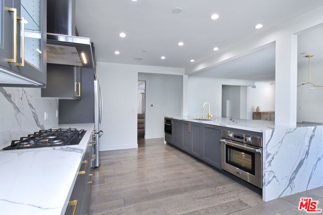 Interior, Kitchen, Marble Walls, Pendant Lights, Recessed Lighting, Stainless Steel Appliances, Wood Texture Flooring