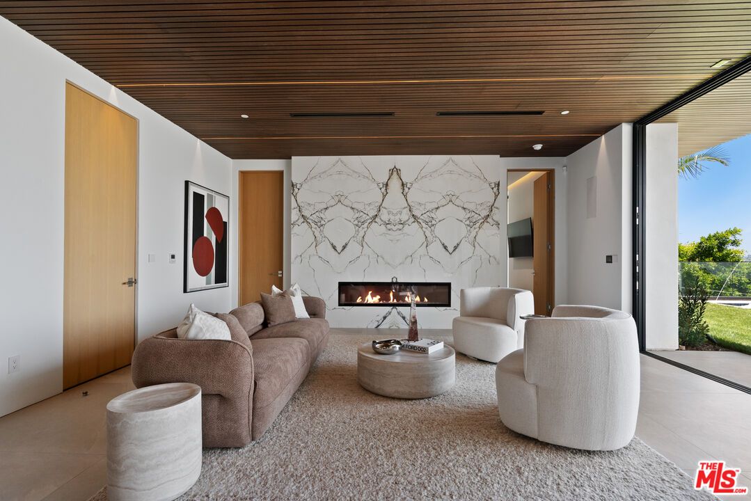Fireplace, Interior, Living room, Marble Walls, Recessed Lighting, Wooden Ceilings