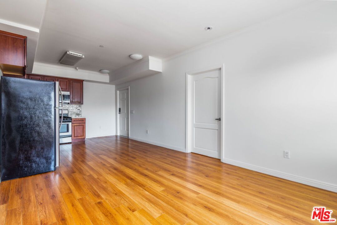 Empty room, Interior, Kitchen, Recessed Lighting, Stainless Steel Appliances, Wood Texture Flooring