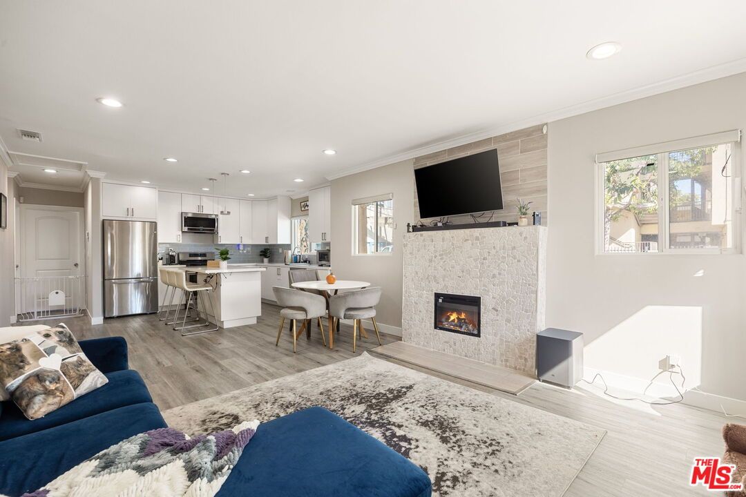 Dining room, Fireplace, Interior, Kitchen, Living room, Pendant Lights, Recessed Lighting, Stainless Steel Appliances, Wood Texture Flooring