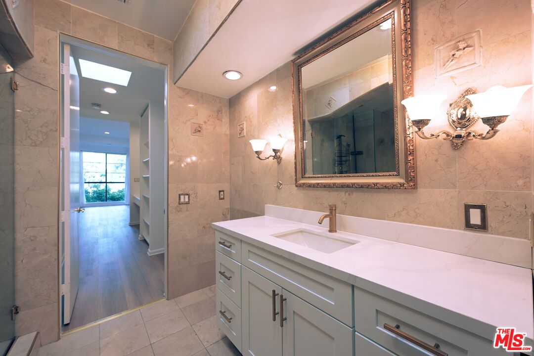 Bathroom, Dual Sink Vanities, Interior, Marble Walls, Recessed Lighting, Wood Texture Flooring