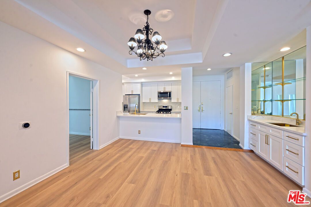 Chandelier, Empty room, Interior, Kitchen, Recessed Lighting, Stainless Steel Appliances, Wood Texture Flooring