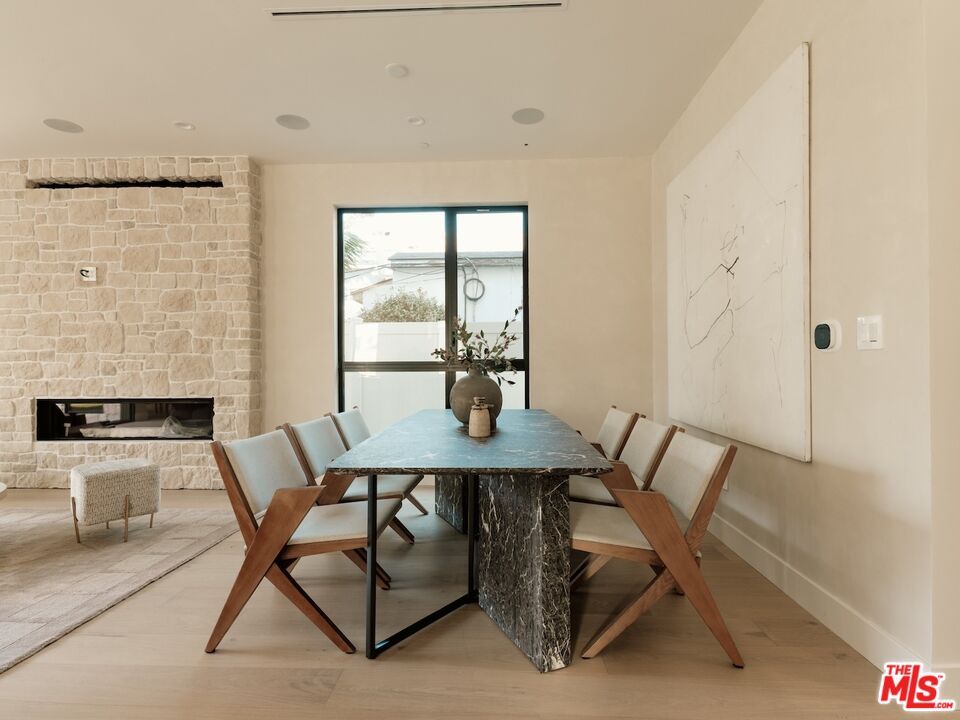 Dining room, Fireplace, Interior, Recessed Lighting, Stone Walls, Wood Texture Flooring