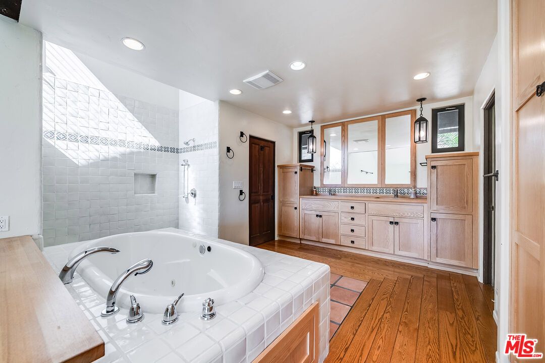 Bathroom, Dual Sink Vanities, Interior, Pendant Lights, Recessed Lighting, Tile Countertops, Wood Texture Flooring