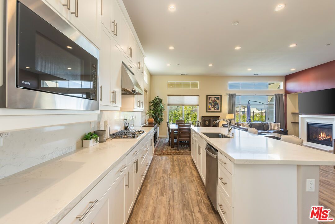 Dining room, Fireplace, Interior, Kitchen, Recessed Lighting, Wood Texture Flooring