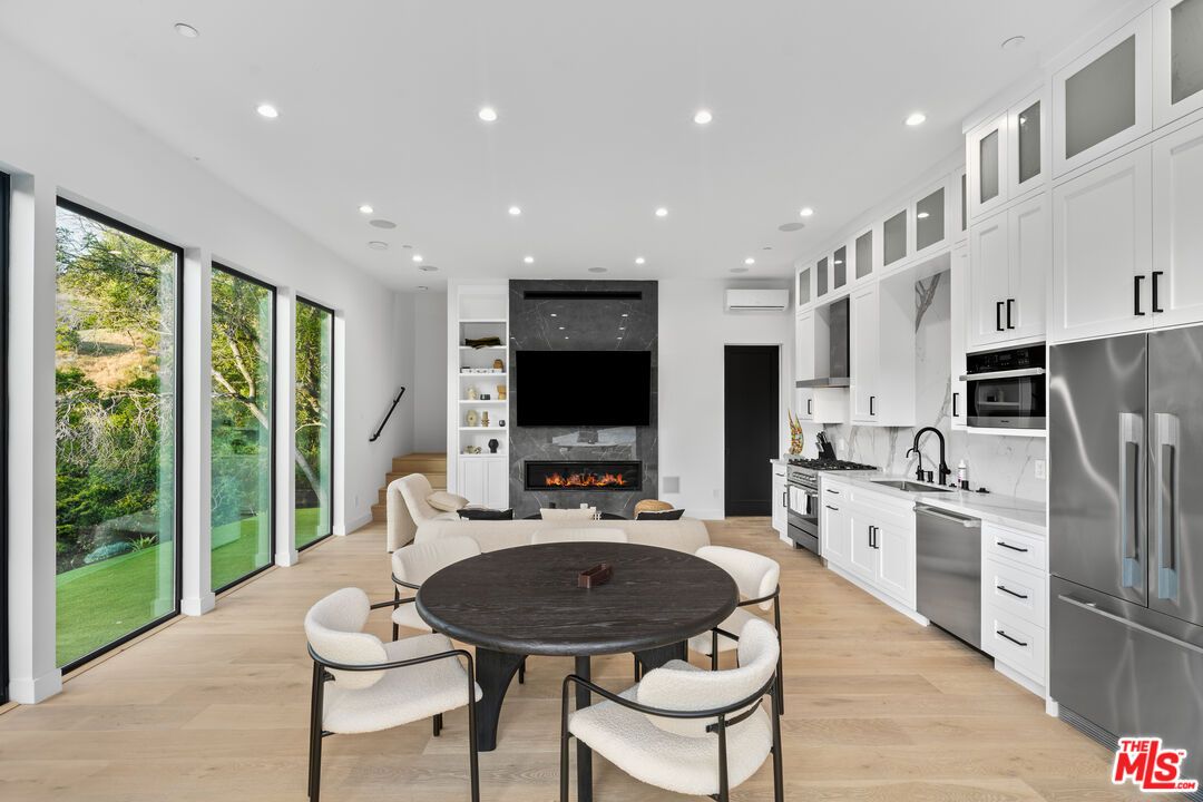 Dining room, Fireplace, Interior, Kitchen, Living room, Recessed Lighting, Stainless Steel Appliances, Wood Texture Flooring