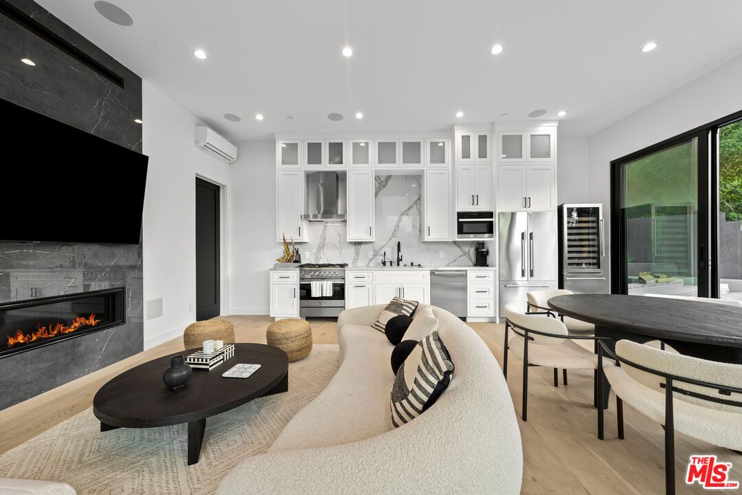 Dining room, Fireplace, Interior, Kitchen, Living room, Marble Walls, Recessed Lighting, Stainless Steel Appliances, Wood Texture Flooring