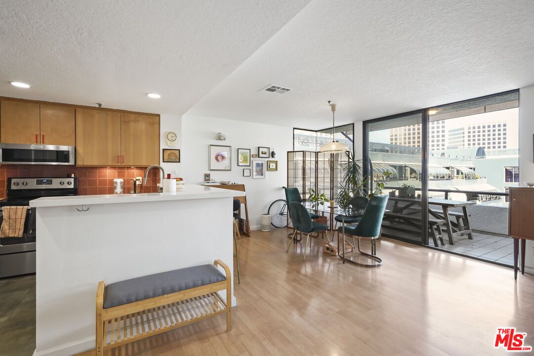 Dining room, Interior, Kitchen, Pendant Lights, Recessed Lighting, Stainless Steel Appliances, Wood Texture Flooring