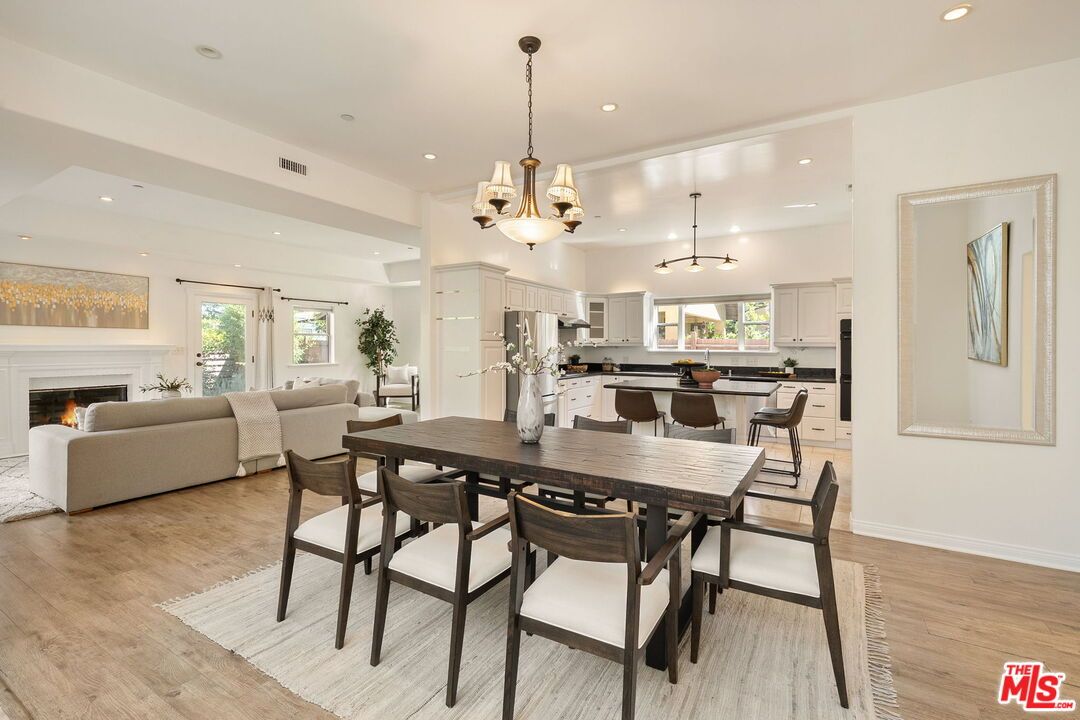 Chandelier, Dining room, Fireplace, Interior, Kitchen, Living room, Pendant Lights, Recessed Lighting, Stainless Steel Appliances, Wood Texture Flooring