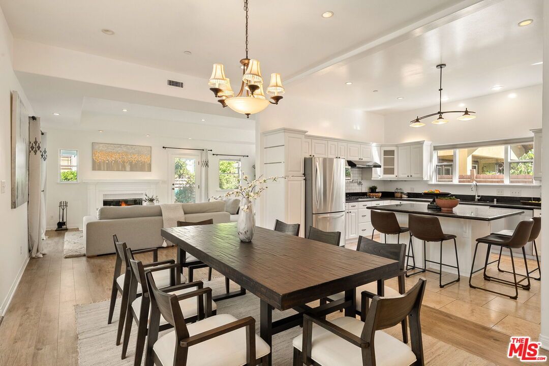 Chandelier, Dining room, Fireplace, Interior, Kitchen, Living room, Pendant Lights, Recessed Lighting, Stainless Steel Appliances, Wood Texture Flooring