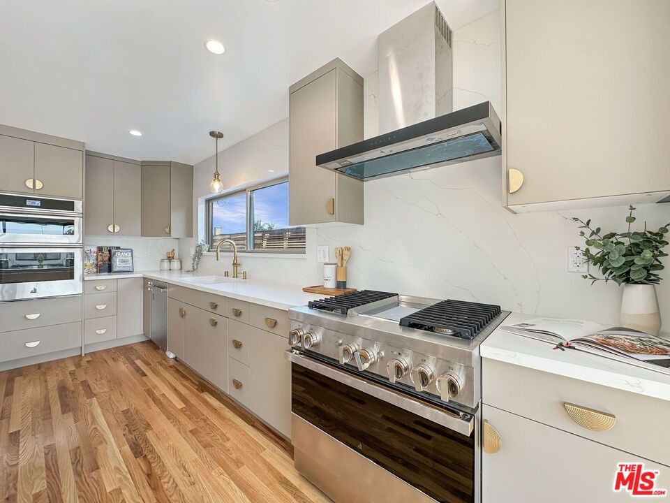 Interior, Kitchen, Marble Walls, Pendant Lights, Recessed Lighting, Stainless Steel Appliances, Wood Texture Flooring