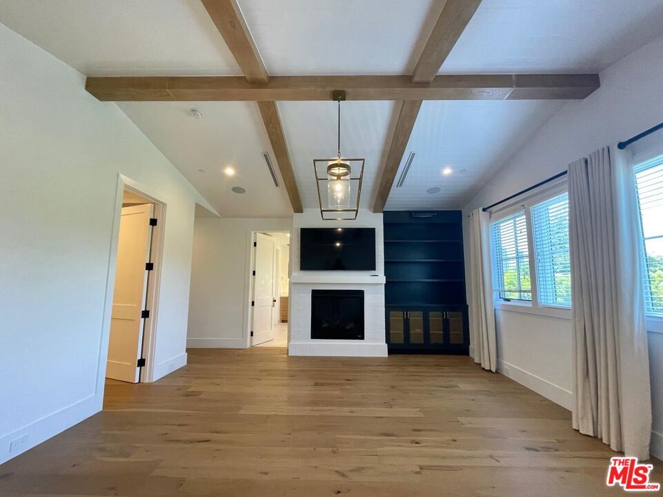 Empty room, Fireplace, Interior, Pendant Lights, Recessed Lighting, Wooden Beams, Wood Texture Flooring