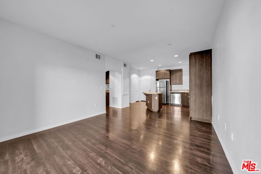 Empty room, Interior, Kitchen, Recessed Lighting, Stainless Steel Appliances, Wood Texture Flooring