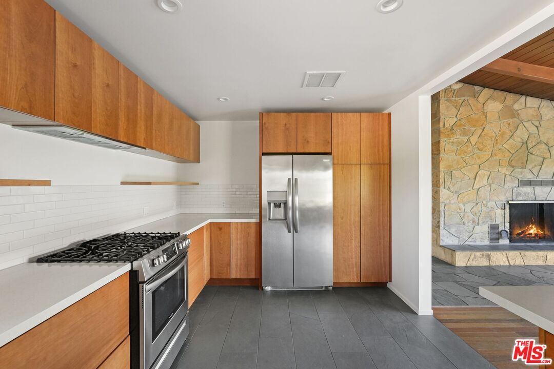 Fireplace, Interior, Kitchen, Recessed Lighting, Stainless Steel Appliances, Stone Walls