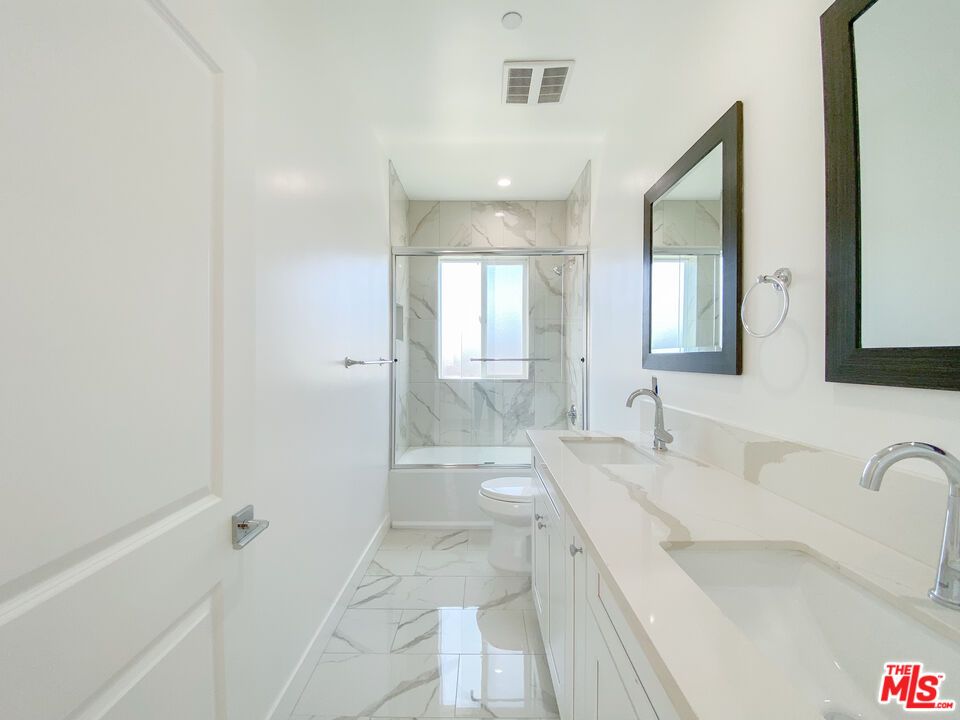 Bathroom, Dual Sink Vanities, Glass Shower, Interior, Marble, Marble Walls, Recessed Lighting