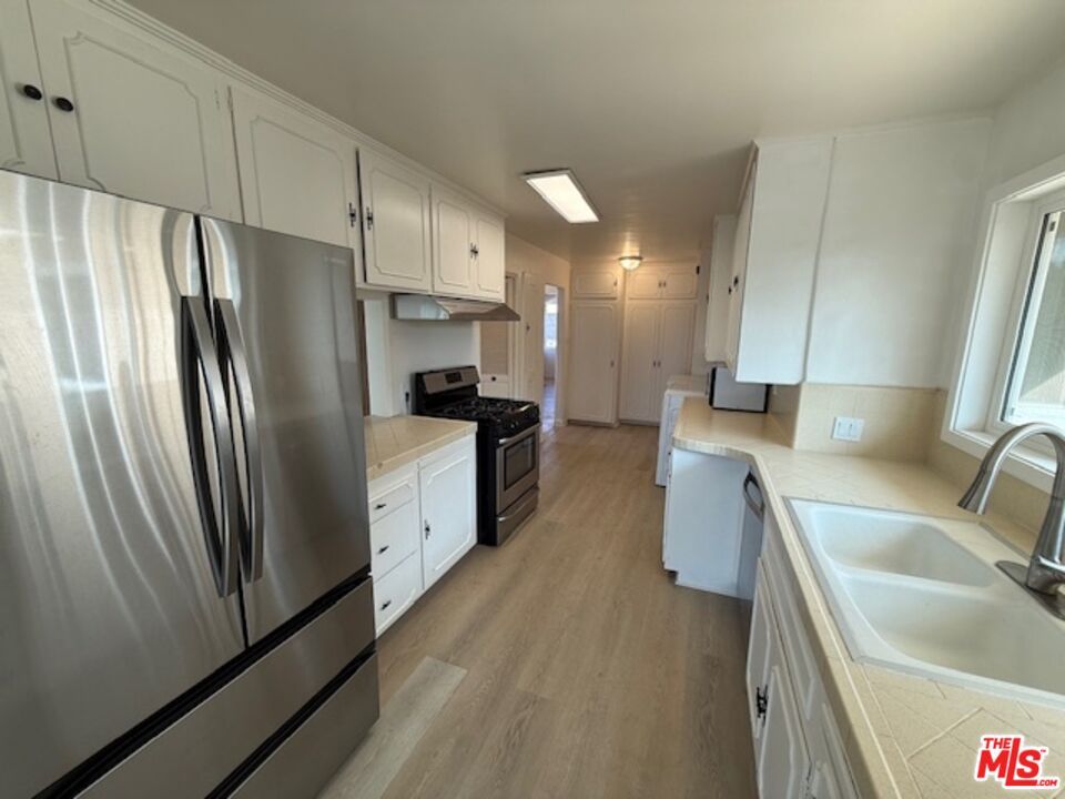 Interior, Kitchen, Stainless Steel Appliances, Tile Countertops, Wood Texture Flooring