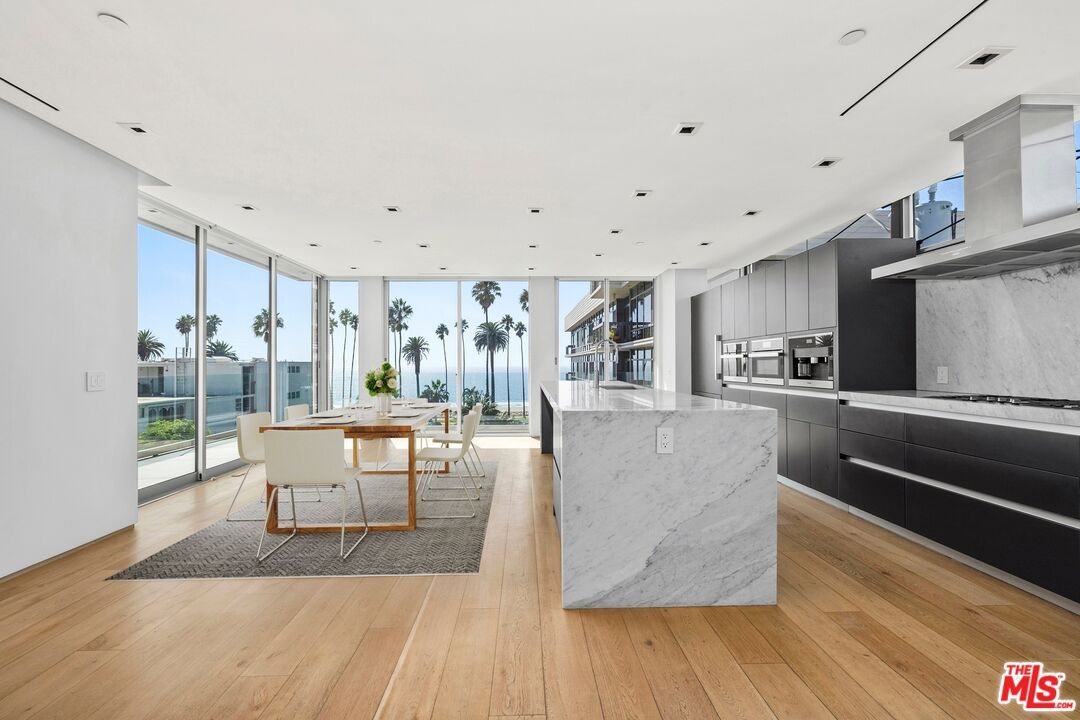 Dining room, Interior, Kitchen, Marble Walls, Recessed Lighting, Stainless Steel Appliances, Water, Wood Texture Flooring