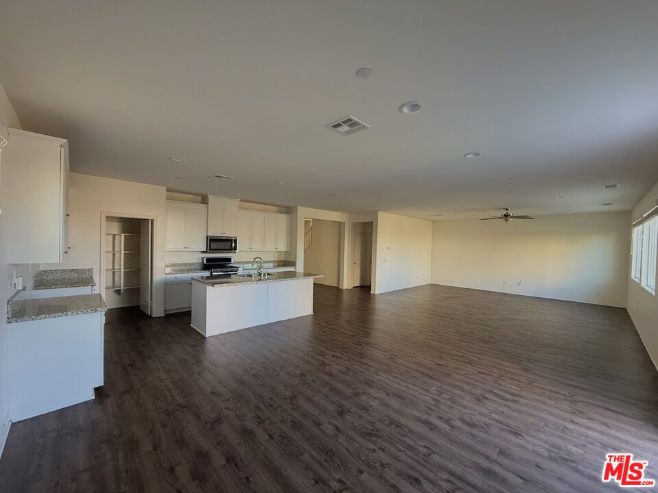 Empty room, Interior, Kitchen, Recessed Lighting, Stainless Steel Appliances, Wood Texture Flooring