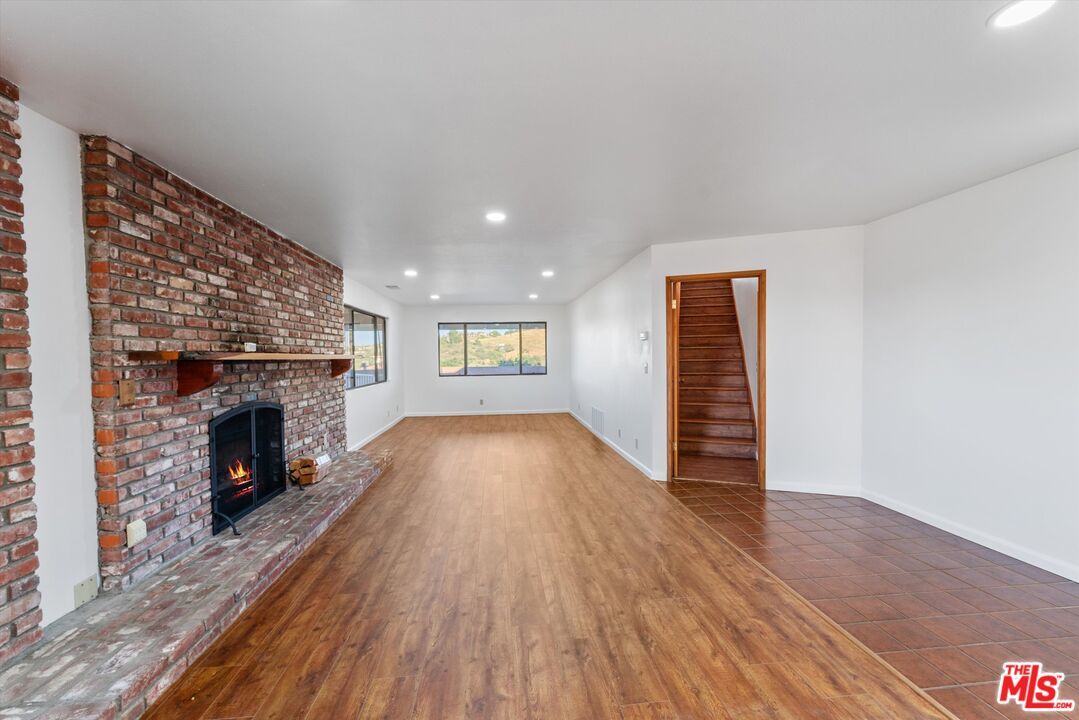 Empty room, Fireplace, Interior, Recessed Lighting, Stone Walls, Wood Texture Flooring