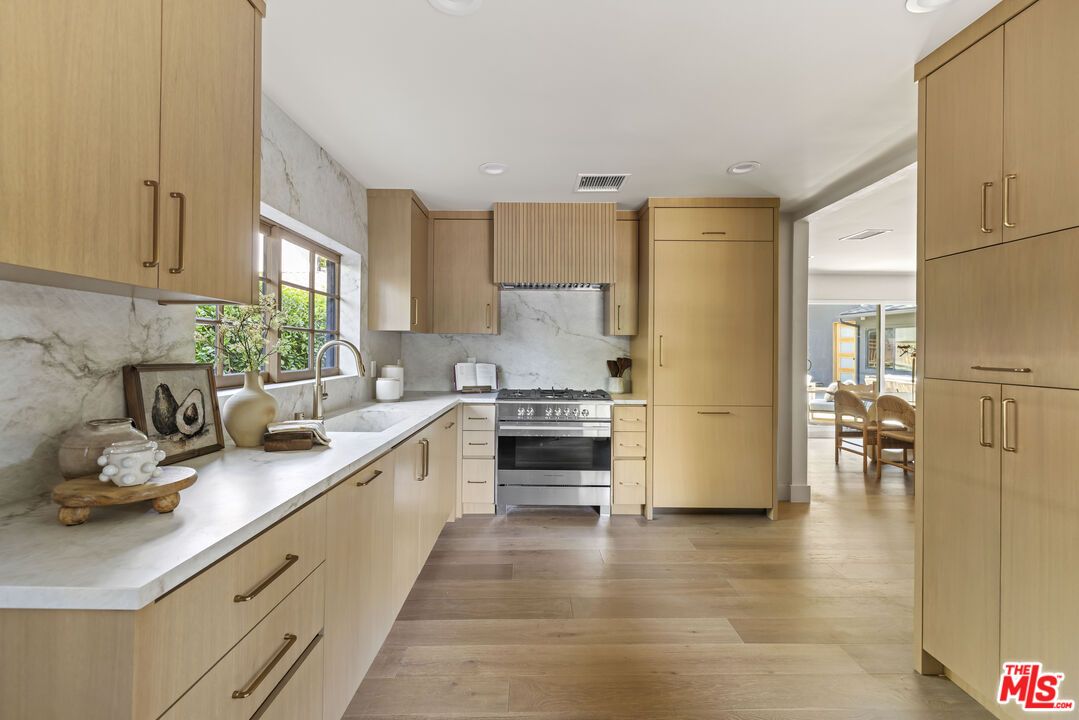 Interior, Kitchen, Marble Walls, Recessed Lighting, Stainless Steel Appliances, Wood Texture Flooring