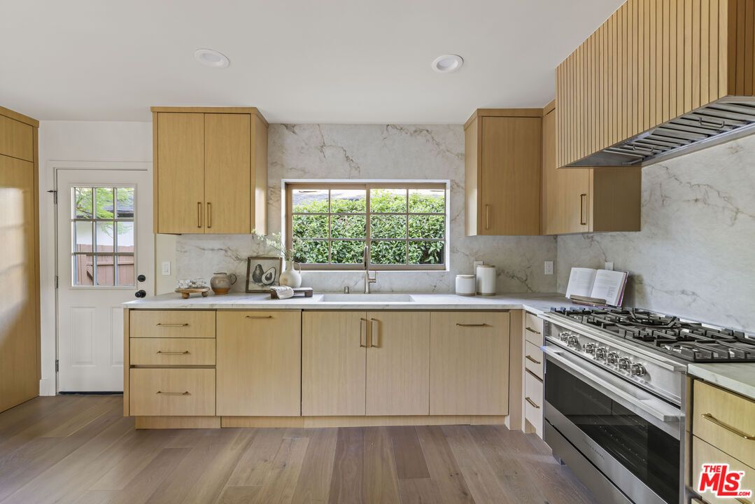 Interior, Kitchen, Marble Walls, Recessed Lighting, Stainless Steel Appliances, Wood Texture Flooring